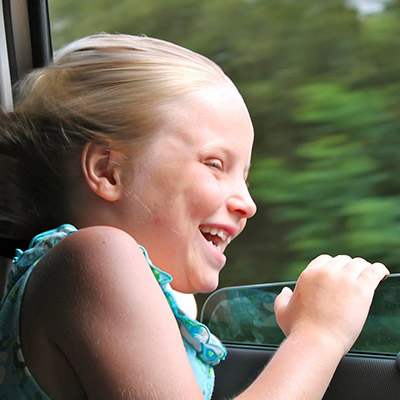 spirited girl enjoying car journey