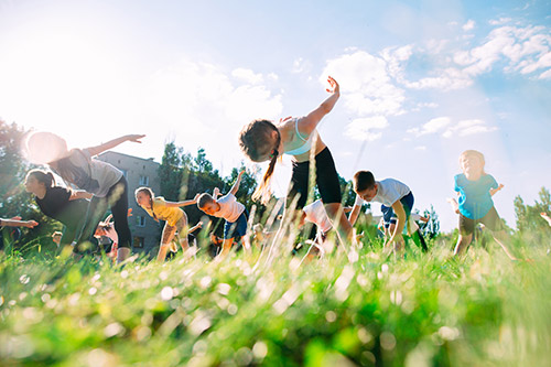 Children enjoying yoga outside