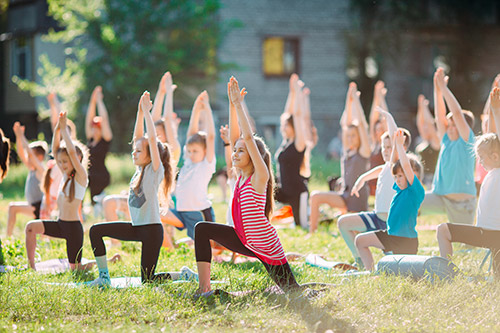 Children enjoying yoga outside